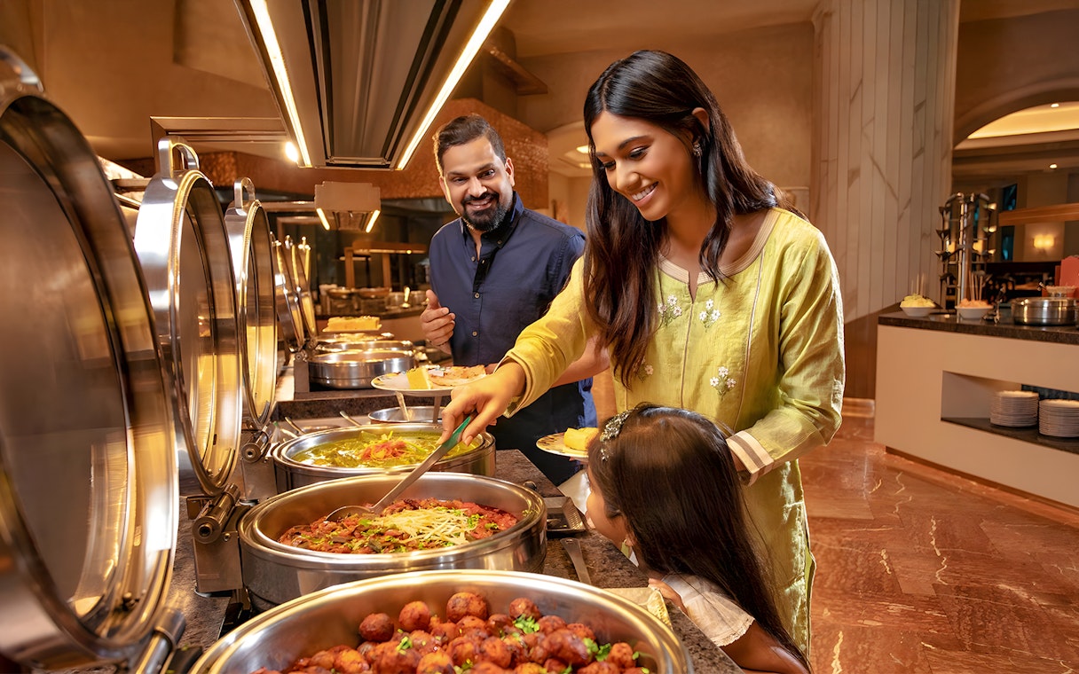 Family enjoying buffet at Kaleidoscope Atlantis Dubai.