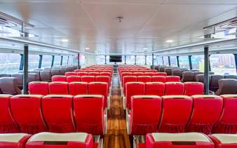 Interior of Singapore to Batam ferry with rows of red seats.