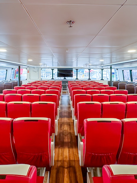 Interior of Singapore to Batam ferry with rows of red seats.