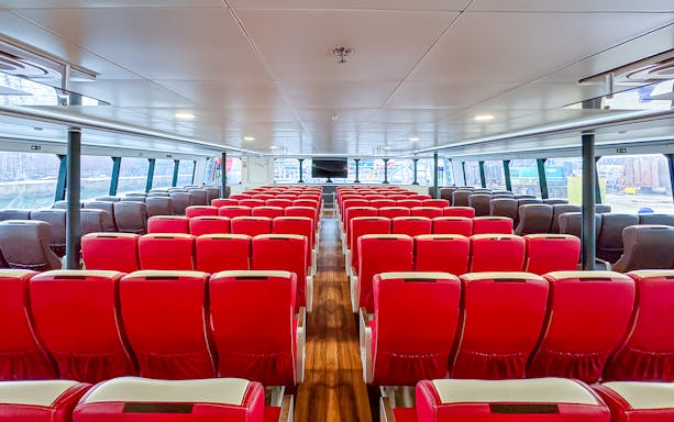 Interior of Singapore to Batam ferry with rows of red seats.