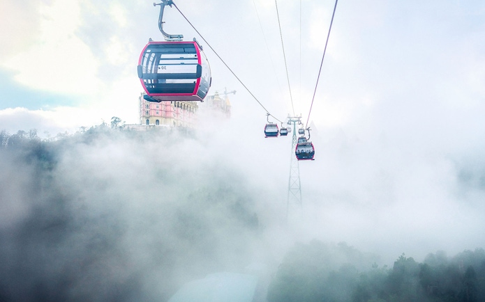 Cable car ascending through mist to Ba Na Hills Mountain Resort, Vietnam.