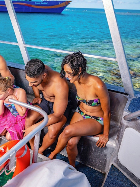 Tourists observing marine life through a glass bottom boat at Fitzroy Island, Great Barrier Reef.