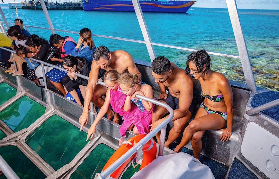 Tourists observing marine life through a glass bottom boat at Fitzroy Island, Great Barrier Reef.
