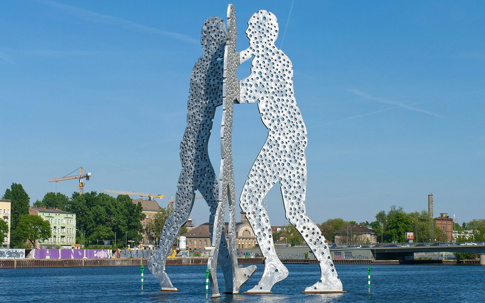 Sculpture of Molecule Man facing each other on the Spree River, Berlin.