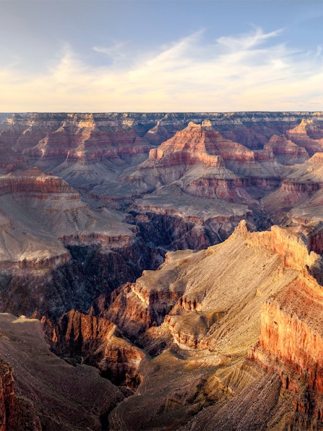 Grand Canyon panoramic view with layered rock formations under a clear sky.