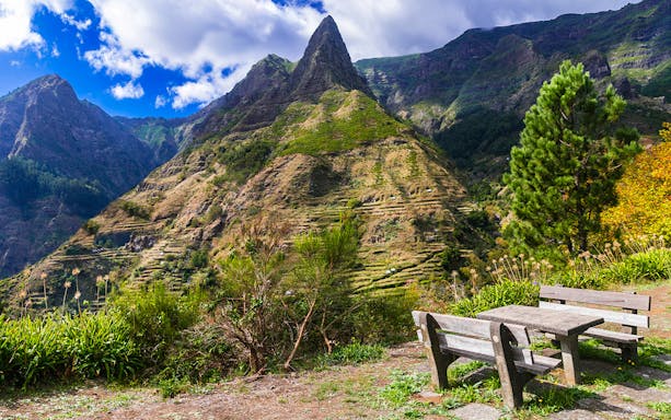 Mountain view with terraced hills and benches, Madeira, Portugal.