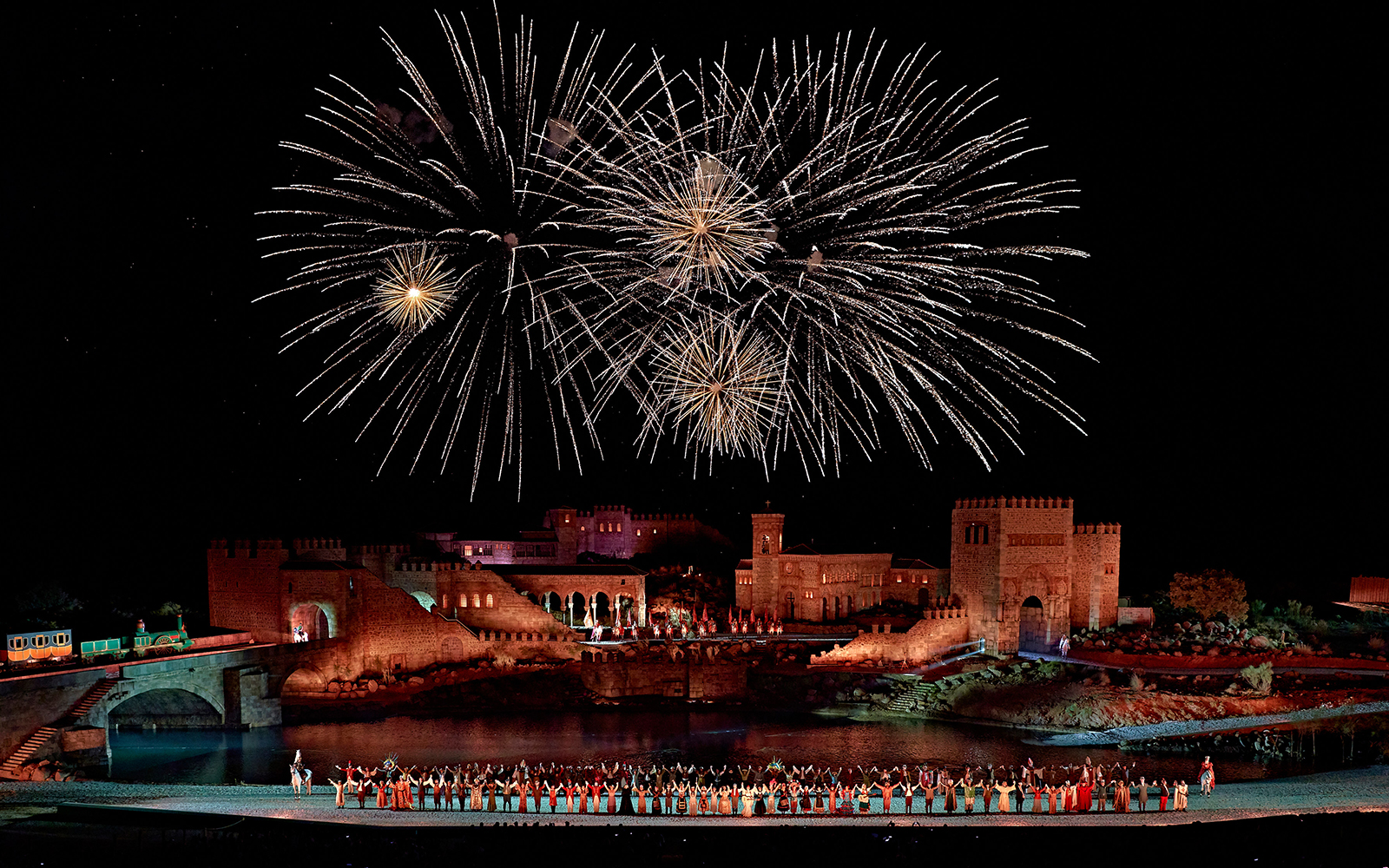 Fireworks over medieval castle during Puy du Fou España night show.