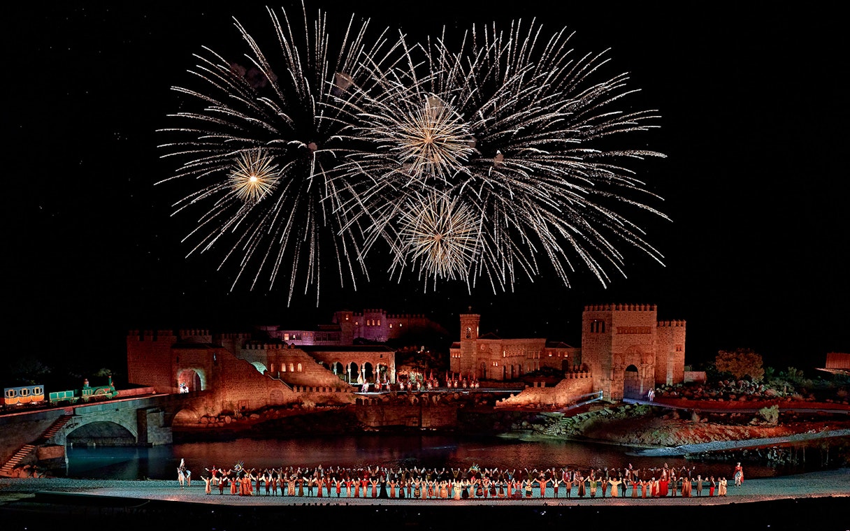Fireworks over medieval castle during Puy du Fou España night show.