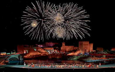 Fireworks over medieval castle during Puy du Fou España night show.