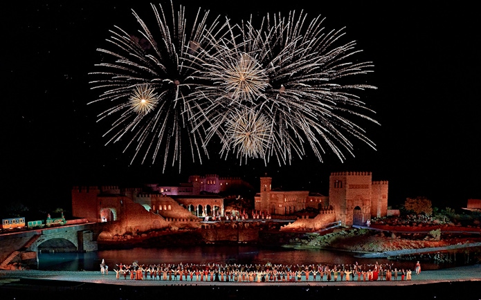 Fireworks over medieval castle during Puy du Fou España night show.