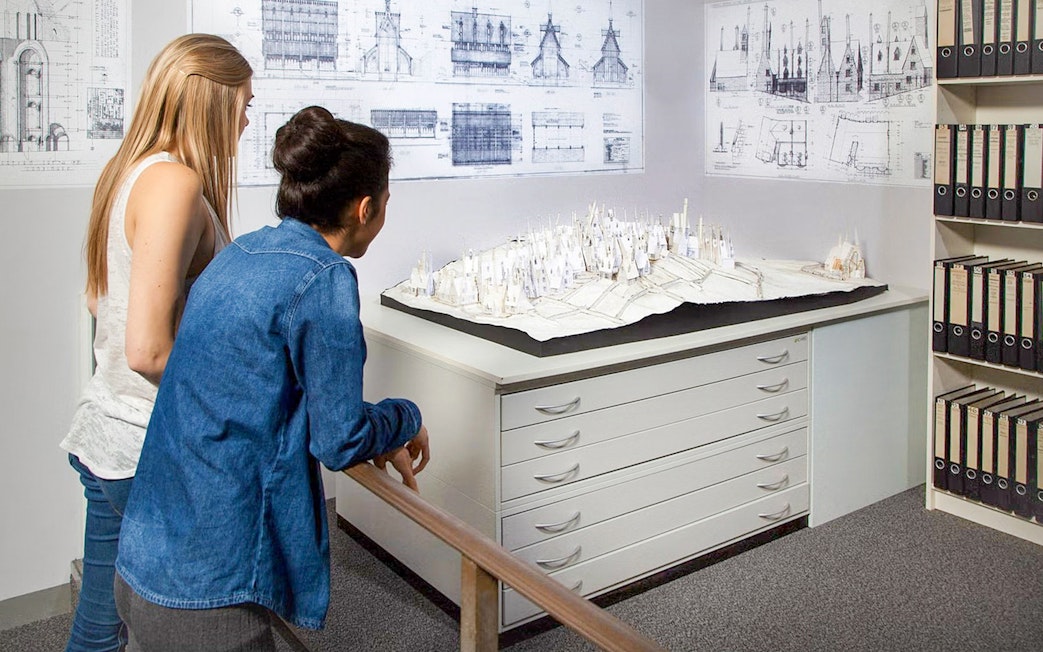 Visitors observing Hogwarts model at Harry Potter Warner Bros. Studio, London tour.