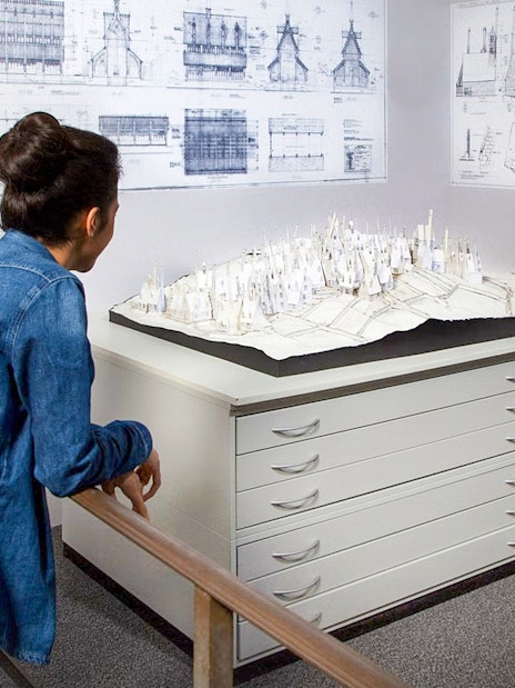 Visitors observing Hogwarts model at Harry Potter Warner Bros. Studio, London tour.