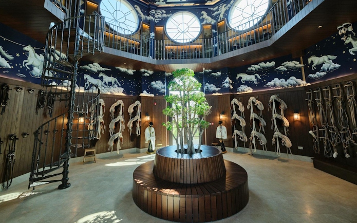 Abu Dhabi Royal Equestrian Arts interior with horse murals and tack display.