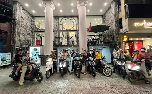 Group on motorbikes ready for street food tour in Ho Chi Minh City's back alleys.