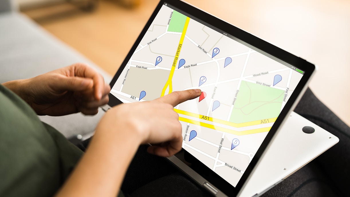 Person interacting with Online GPS Location Map Search