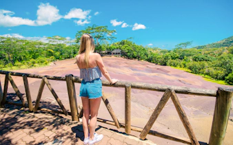 Girl viewing Chamarel Seven Coloured Earth, Mauritius.