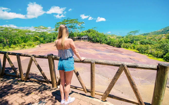 Girl viewing Chamarel Seven Coloured Earth, Mauritius.