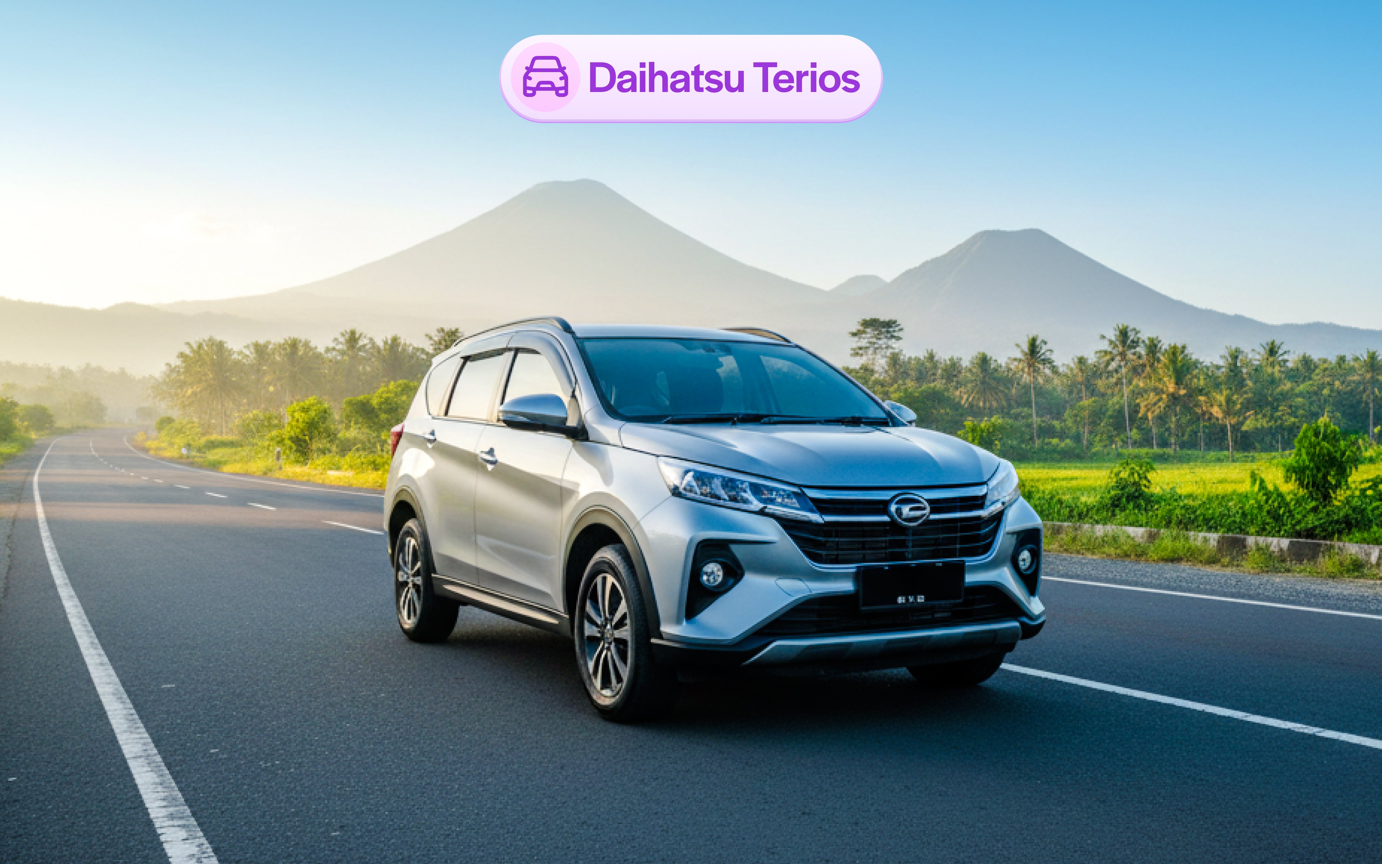 Daihatsu Terios on a scenic road in Bali with mountains in the background.