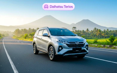 Daihatsu Terios on a scenic road in Bali with mountains in the background.