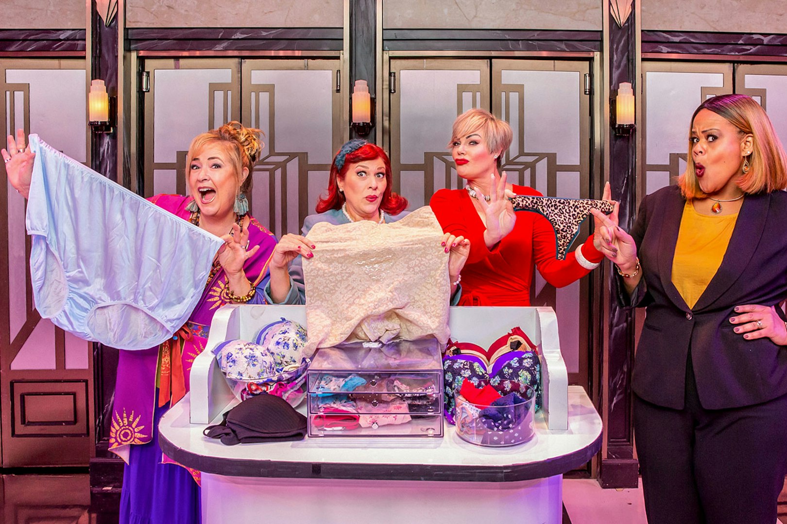 Four women on stage holding underwear in a scene from Menopause the Musical.