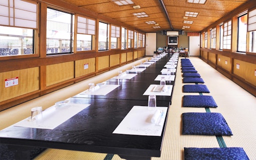 Tatami dining setup on Asakusa Yakatabune cruise with place settings and cushions.