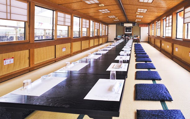 Tatami dining setup on Asakusa Yakatabune cruise with place settings and cushions.