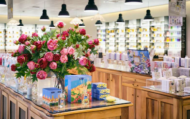Fragonard Perfume Factory display with Flower of the Year eau de toilette and floral arrangement.