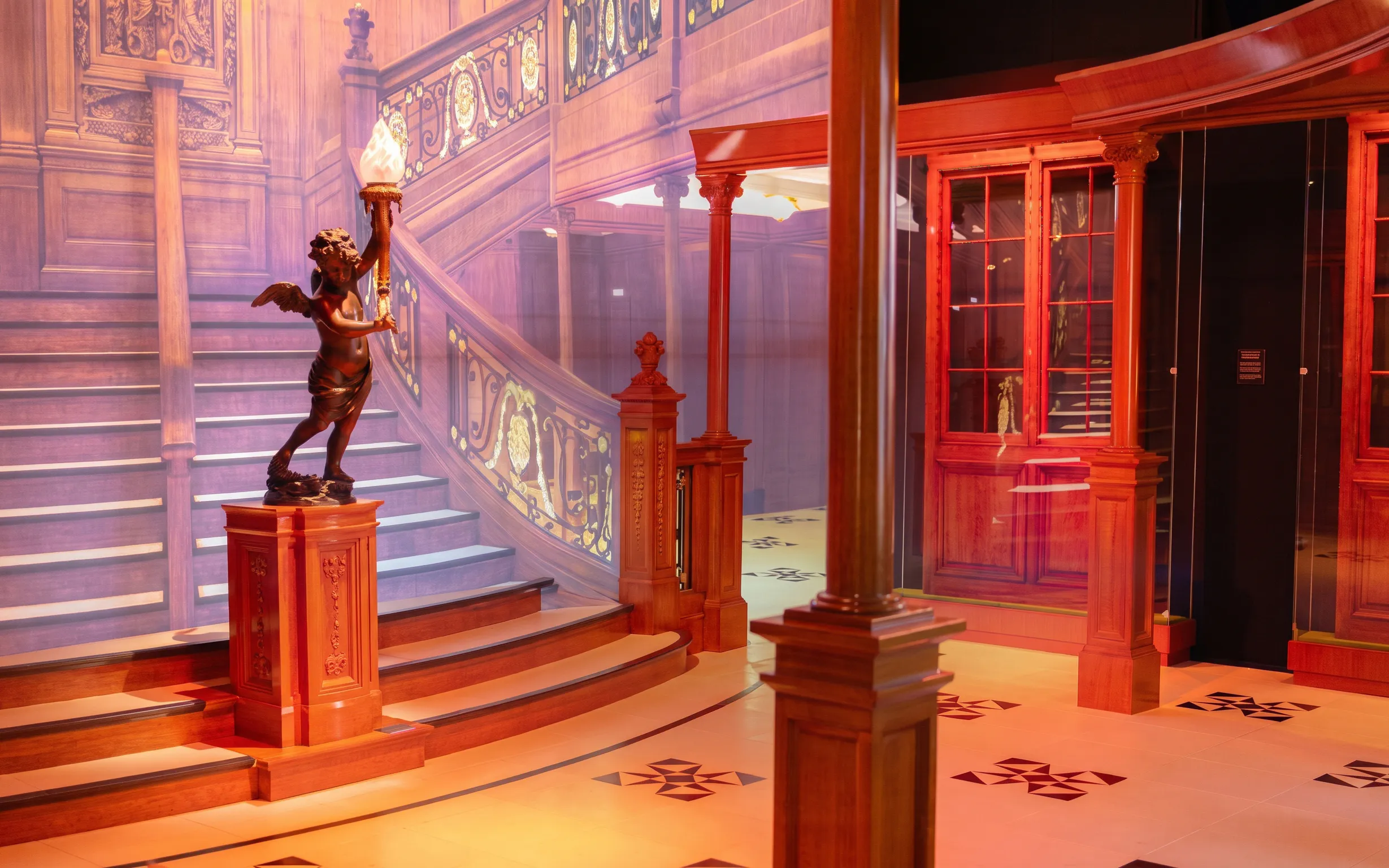Titanic grand staircase replica at immersive exhibit in Houston.