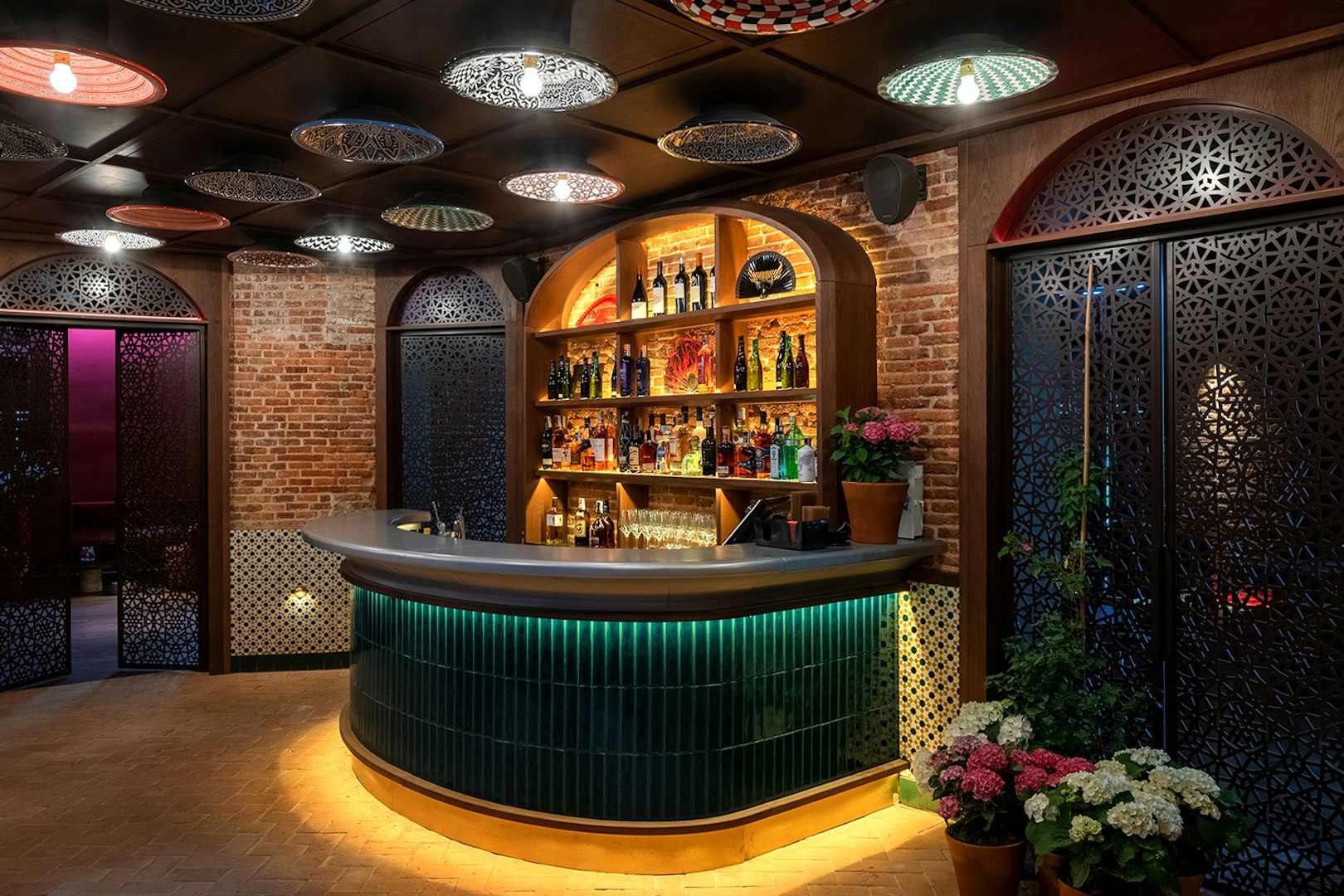 Bar area at Flamenco De Leones Show venue with decorative ceiling and brick walls.