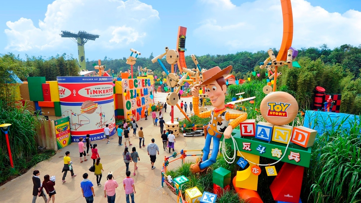 Visitors exploring Toy Story Land with Woody statue at Disneyland Hong Kong.