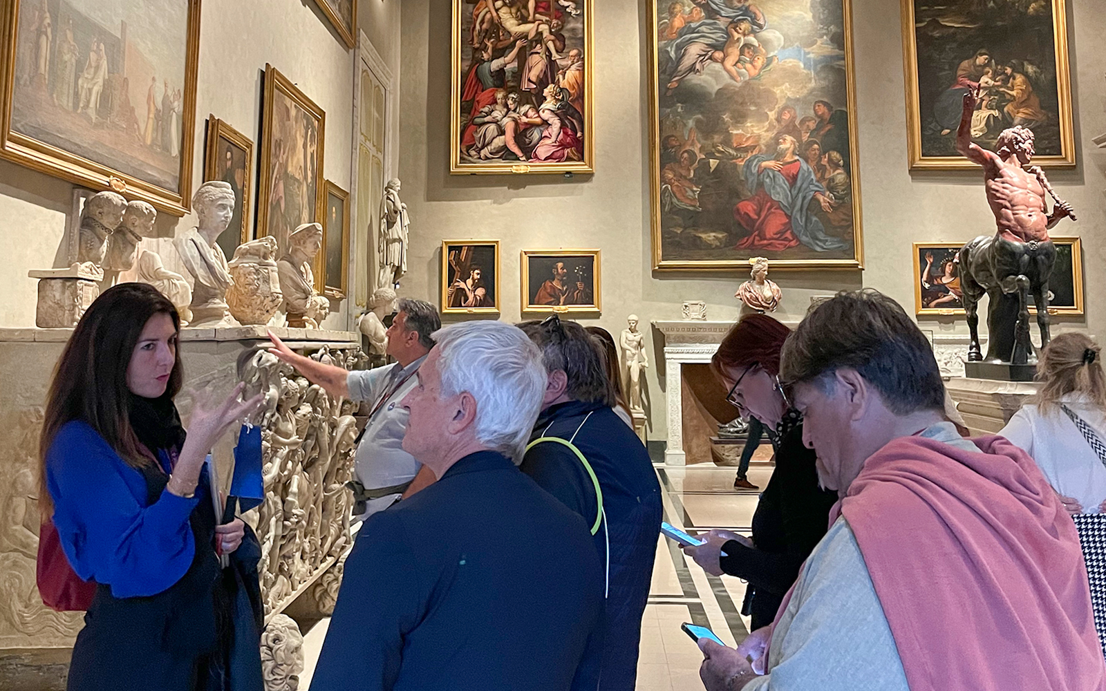 Tour group exploring art and sculptures at Doria Pamphilj Gallery in Rome.