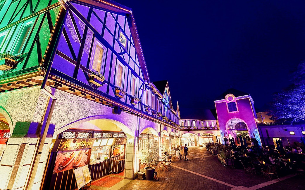 Kobe Nunobiki Herb Gardens illuminated at night with visitors exploring.