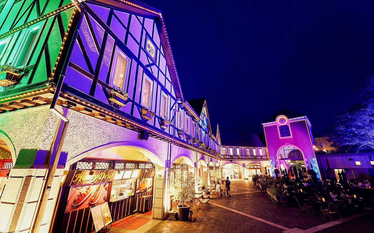Kobe Nunobiki Herb Gardens illuminated at night with visitors exploring.