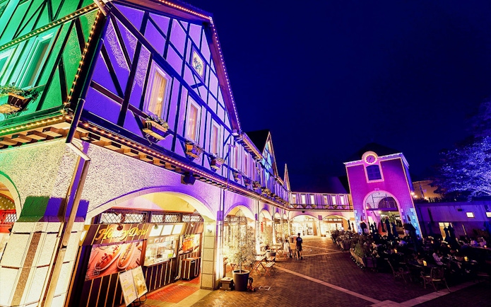 Kobe Nunobiki Herb Gardens illuminated at night with visitors exploring.