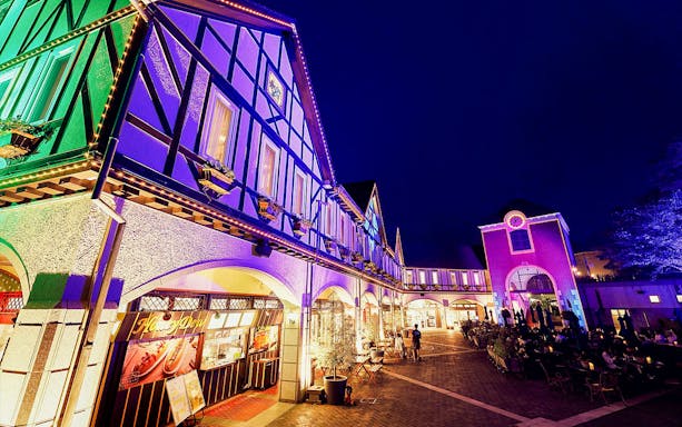 Kobe Nunobiki Herb Gardens illuminated at night with visitors exploring.
