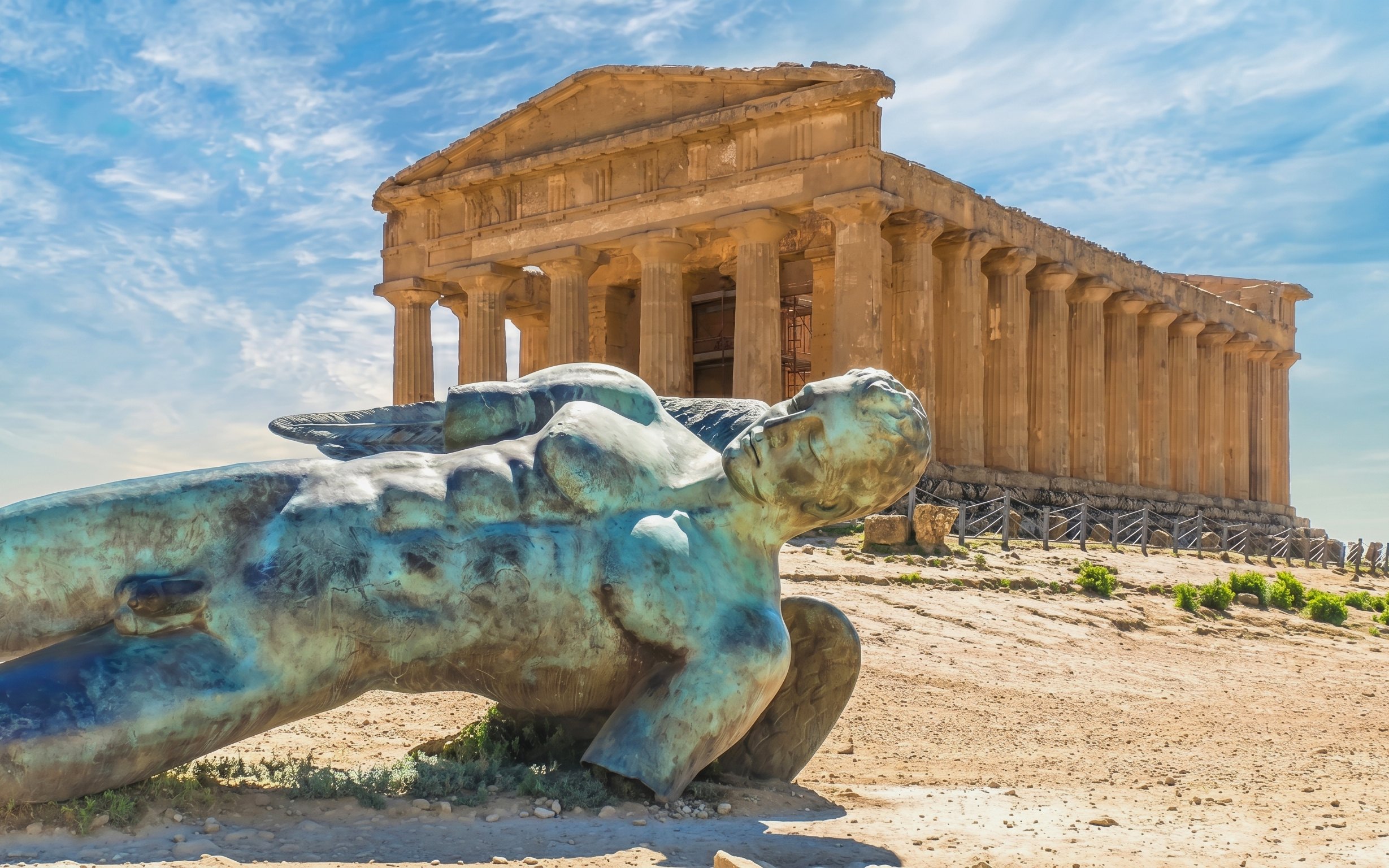 Ancient Greek temple and fallen statue in Agrigento, Sicily.