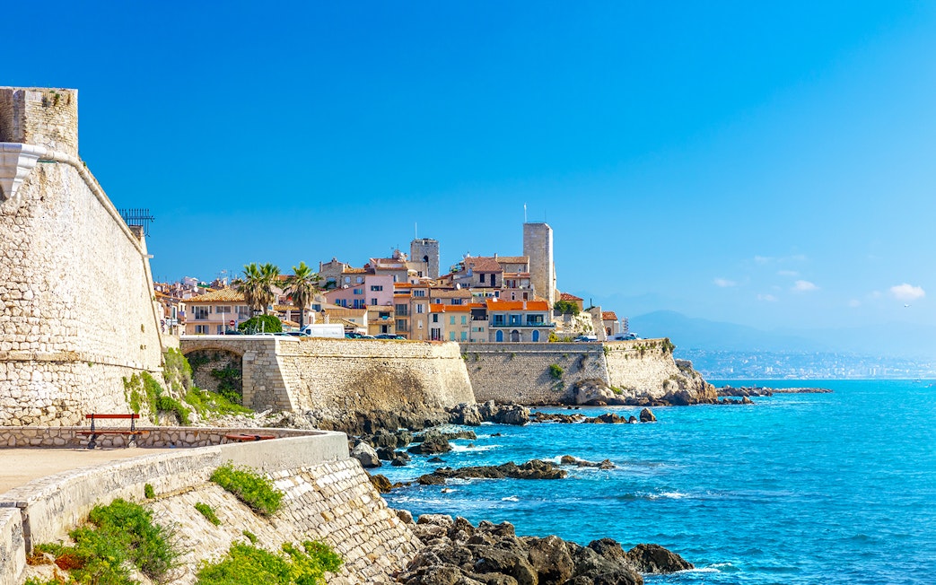 Old town of Antibes with stone walls and Mediterranean Sea in Provence, France.