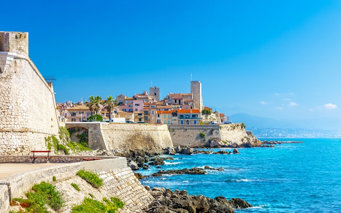Old town of Antibes with stone walls and Mediterranean Sea in Provence, France.