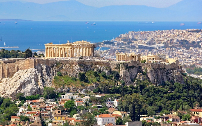 Aerial view of the Acropolis in Athens with the Parthenon and cityscape in the background.