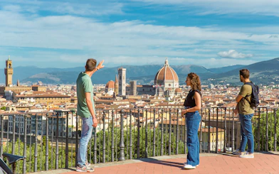 Tourists overlooking Florence skyline with Duomo on E-bike tour.