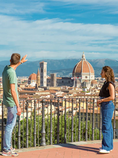 Tourists overlooking Florence skyline with Duomo on E-bike tour.