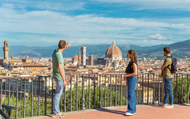 Tourists overlooking Florence skyline with Duomo on E-bike tour.
