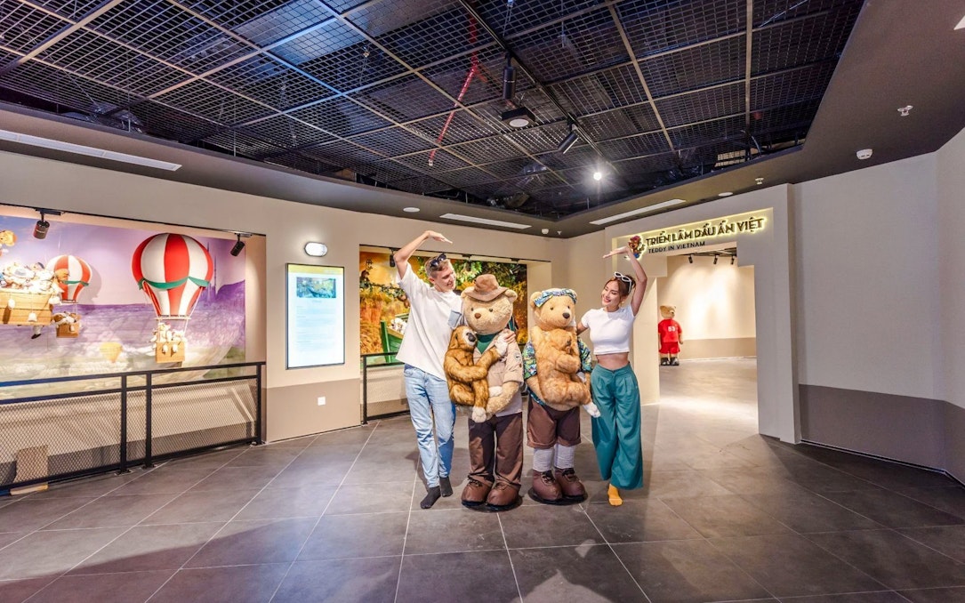 Visitors posing with teddy bear mascots at Teddy Bear Museum, Vietnam.