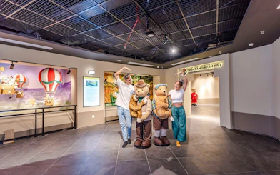 Visitors posing with teddy bear mascots at Teddy Bear Museum, Vietnam.