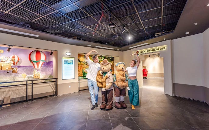 Visitors posing with teddy bear mascots at Teddy Bear Museum, Vietnam.