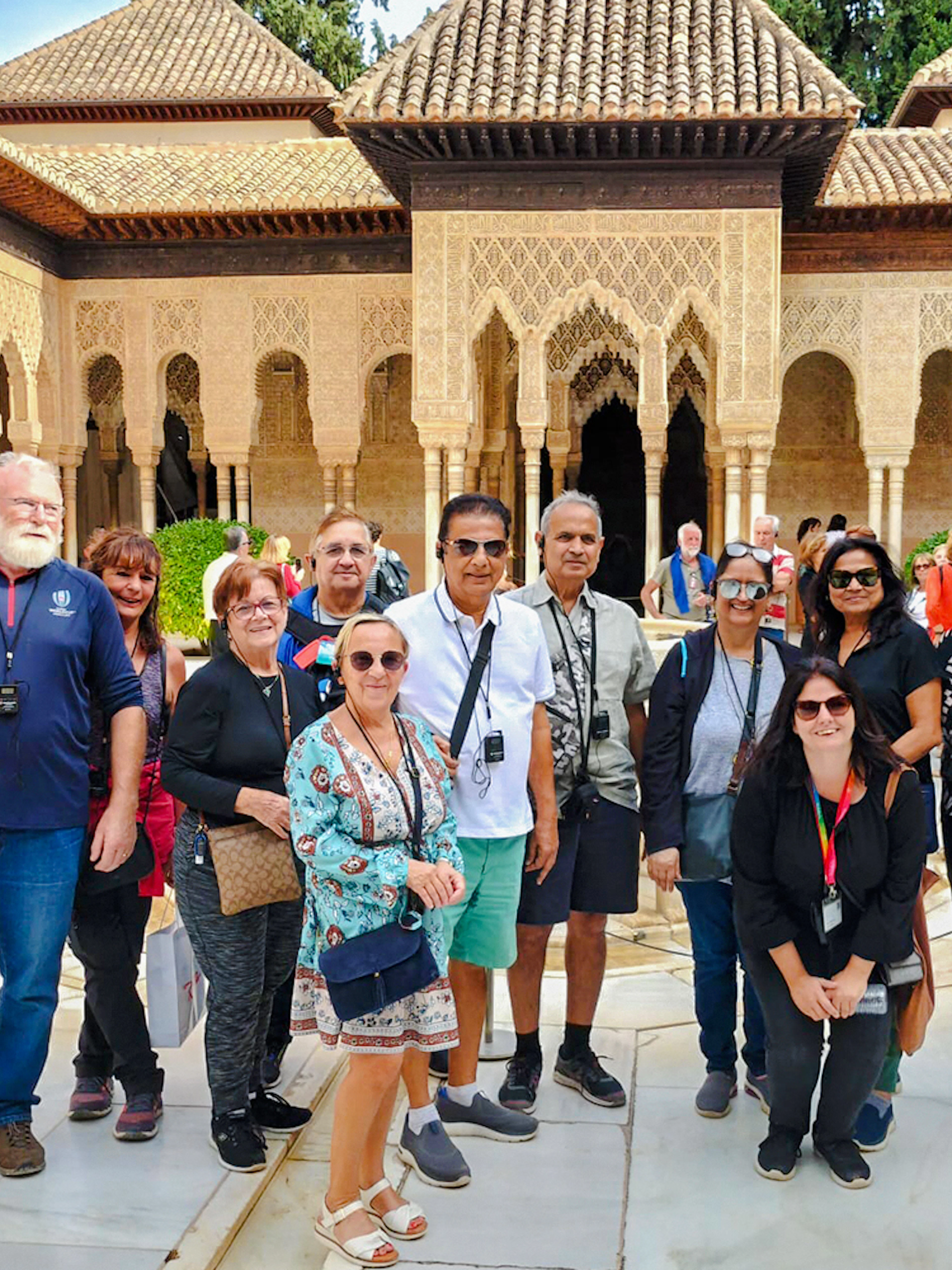 Visitors in the Court of the Lions, Nasrid Palaces, Alhambra, Granada.