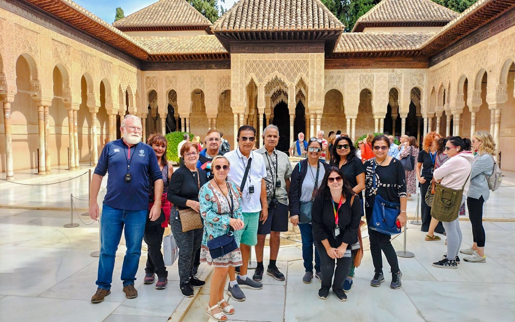 Visitors in the Court of the Lions, Nasrid Palaces, Alhambra, Granada.
