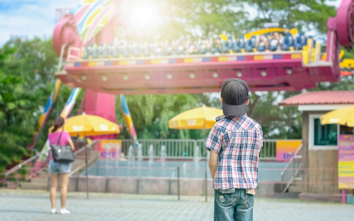 Child watching a ride at Dream World Bangkok amusement park.