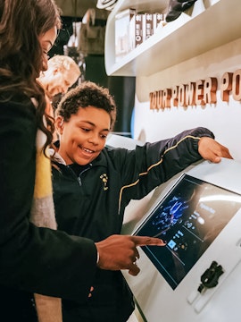 Visitors interacting with a digital display at Lift 109 exhibit.
