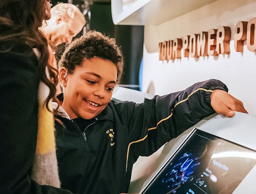 Visitors interacting with a digital display at Lift 109 exhibit.